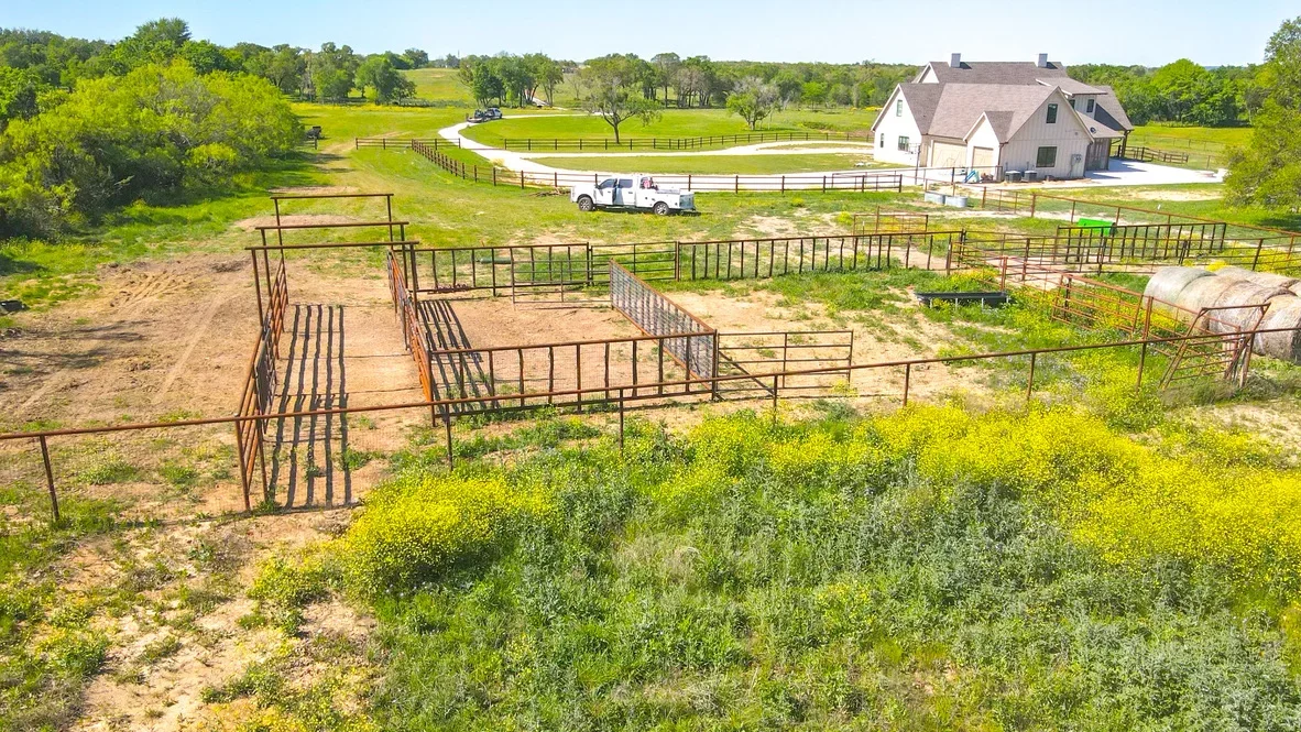 Steel pipe corrals and livestock handling pens with compacted earth work on rural property